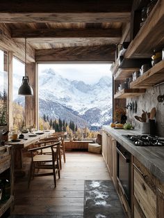 an open kitchen and dining area with mountains in the background