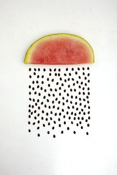 a slice of watermelon with black dots on it