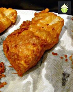 a close up of food on a paper towel with text overlay that reads beer battered fish