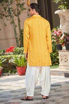 Mustard full sleeve short kurta with chikankari embroidery, accentuated with zari embellishments. Paired with a salwar.
Components: 2
Pattern: Embroidery
Type Of Work: Chikankari, Zari
Neckline: Stand Collar
Sleeve Type: Full Sleeves
Fabric: Kurta: Georgette, Salwar: Cotton Silk Tussar
Color: Yellow
Other Details: 

Zari embellishments in vertical pattern
Occasion: Sangeet - Aza Fashions Yellow Chikankari Kurta, Salwar For Men, Yellow Kurta, Chikankari Embroidery, Short Kurta, Vertical Pattern, Pattern Embroidery, Embroidered Shorts, Fashion App