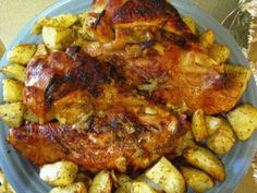 a blue plate topped with chicken and potatoes