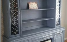 a blue bookcase sitting next to a window