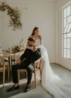 a bride and groom sitting at a table