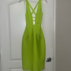 a lime green dress hanging on a door