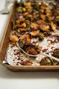 a pan filled with cooked brussel sprouts and nuts