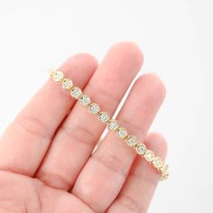 Featuring a total carat weight of 1.44. Crafted to perfection, this bracelet sparkles with every movement, making it a luxurious addition to any jewelry collection or a stunning gift for someone special. Bracelet length: 7"Bracelet width: 5 mmClosure style: Tennis claspMaterial: 14K Yellow GoldWeight: 13.9gDiamonds: 36 x 0.04Ctw = 1.44CtwColor And Clarity: G-H/SI1Total Carat Weight: 1.44Ctw For more of our jewelry products, please visit our shop 777jewelry Free shipping on all orders within the USA. International shipping available. We only sell real gold jewelry. We do not sell gold plated or gold filled jewelry. We offer a 30 day money back guaranteed return on all orders. Our goal is to make every customer satisfied. Fine Jewelry Diamond Bracelet With Channel Set, Luxury Diamond Tennis Bracelet With Channel Set, Channel Set Diamond Bracelet In Fine Jewelry Style, Luxury Diamond Channel Set Tennis Bracelet, Luxury Channel Set Diamond Tennis Bracelet, Fine Jewelry Diamond White Diamond Bracelet With Channel Set, Diamond White Channel Set Diamond Bracelet, Fine Jewelry Diamond Bracelets With Channel Set, White Gold Cubic Zirconia Diamond Bracelet With Bezel Setting