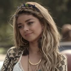 a close up of a person with long hair and wearing a necklace on her neck