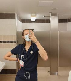 a nurse taking a selfie in the bathroom