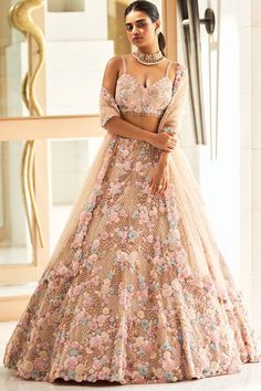 Featuring a champagne and pink lehenga in net base with floral crystal embroidery. It is paired with a matching cutwork dupatta, an embellished belt, and a blouse.   FIT: Fitted at bust and waist. COMPOSITION: Net. CARE: Dry clean only. Lehenga Designs Latest, Embroidered Bridal Lehenga, Crystal Embroidery, Champagne Pink, Embellished Belt, Net Lehenga, Arm Jewelry, Pink Lehenga