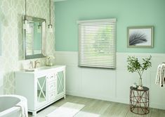 a bathroom with blue walls and white furniture