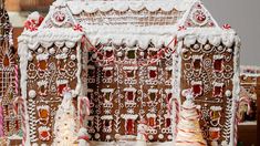 a gingerbread house decorated with icing and candy canes for the holiday season