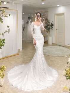 a woman in a white wedding dress is talking on her cell phone while looking at the camera