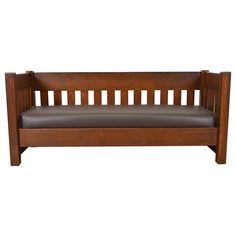 a wooden bench with brown leather upholstered seat