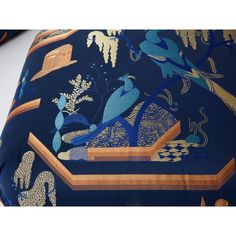 a blue and gold pillow with birds on it