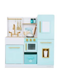 a toy kitchen with blue cabinets and gold trimmings on the doors, drawers, and shelves