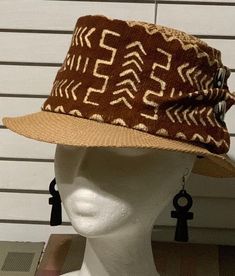 This is a rustic mudcloth fedora that is great for Spring and Summer. The fedora is accented with mudcloths from Mali. This african hat is also accented with trade beads. Don’t delay order yours today. Brown Artisan Straw Hat With Short Brim, Artisan Brown Straw Hat With Short Brim, Adjustable Brown Woven Fedora, Brown Woven Brimmed Fedora, Western Brown Woven Fedora, Western Style Brown Fedora With Woven Detail, Western Brown Fedora With Woven Detail, Handwoven Brown Hat Bands With Curved Brim, Brown Woven Straw Hat Artisan Style