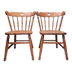 two wooden chairs with hearts on them