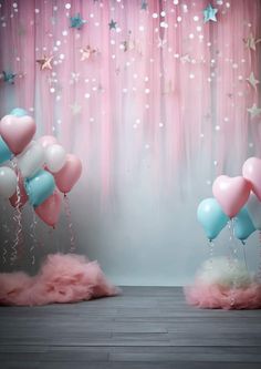 pink and blue balloons are in front of a curtain with stars hanging from the ceiling