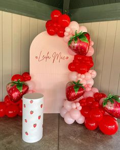 the balloon arch is decorated with strawberries and strawberrys for a valentine's day party