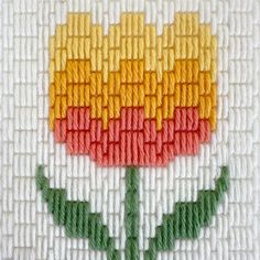 a close up of a cross stitch pattern with a flower in the center on a white background