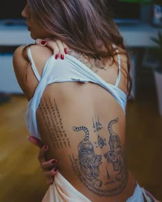 a woman with tattoos on her back