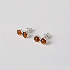 Little infinite studs are an everyday earring with a hit of color. made in sterling silver and semi precius gem stones they measure 1.2 cm x 0.6 cm hand made in Queens NY lead time is two weeks, email hello@sunabonometti.com if you need them sooner Modern Sterling Silver Earrings With Cabochon, Classic Amber Sterling Silver Earrings, Everyday Sterling Silver Cabochon Jewelry, Minimalist Sterling Silver Amber Jewelry, Minimalist Amber Sterling Silver Jewelry, Modern Silver Earrings With Birthstone, Modern Silver Birthstone Earrings, Dainty Amber Sterling Silver Jewelry, Classic Sterling Silver Birthstone Earrings