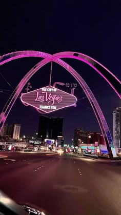 the las vegas sign is lit up in pink for valentine's day on fremont street