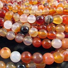 multicolored glass beads are displayed on a table