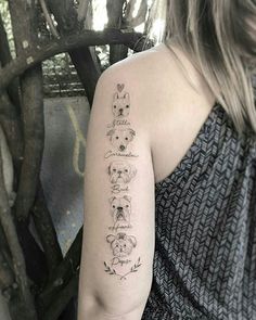 a woman with a tattoo on her arm has four dogs and the words happy written in cursive font