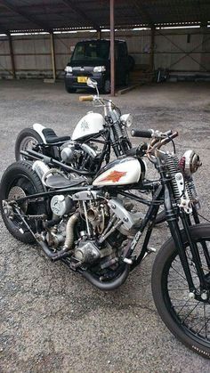 two motorcycles parked next to each other in a parking lot