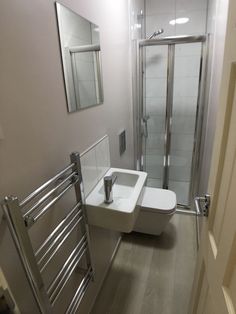 a bathroom with a toilet, sink and shower stall