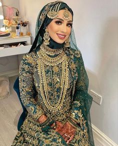 a woman in a green and gold wedding outfit