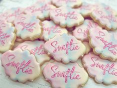 some cookies are decorated with pink and white icing