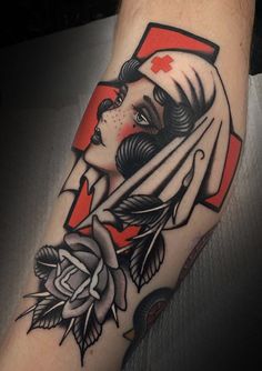 a woman's arm with a red cross on it