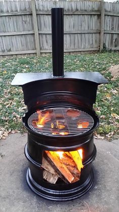 an open fire pit sitting in the middle of a yard