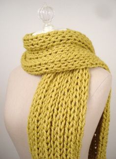 a yellow knitted scarf on a mannequin