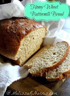 a loaf of honey wheat buttermilk bread sitting on top of a cutting board