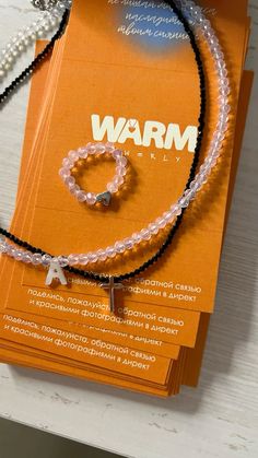 an orange box with two bracelets and a necklace on it's front cover