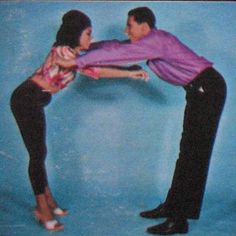 a man and woman are dancing together in front of a blue background with an advertisement for the dance company