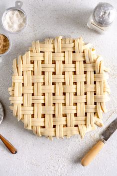 a pie crust on a table next to other baking supplies