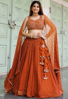 Embroidered Georgette Lehenga in Orange Georgette Embroidery Lehenga, Orange Lehenga Choli, Crop Blouse Designs For Lehenga, Terracotta Lehenga, Orange Chaniya Choli For Navratri, Lehenga Models For Stitching, Orange Traditional Outfits, Rust Colour Lehenga, Lehnga Designs 2024