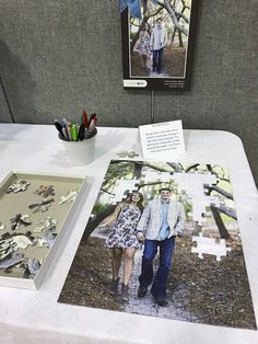 a couple is walking down the path in front of some puzzles on a table