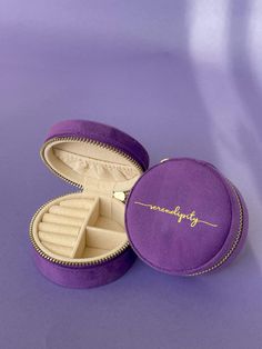 an open jewelry box on a purple surface