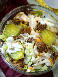 a salad in a bowl with dressing and cheese on top is ready to be eaten