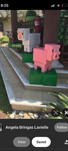 an image of some pink and green paper pigs on the steps in front of a house