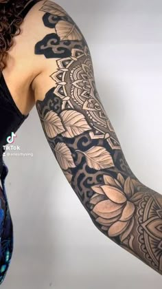 a woman's arm with tattoos on it