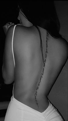 the back of a woman's body with writing on it