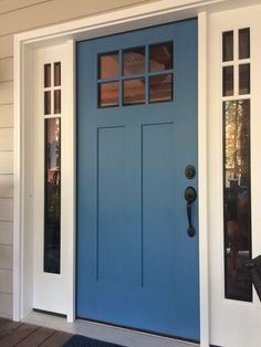 a blue front door with two sidelights and glass panels on the top half of it