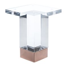 an acrylic glass and brass side table on a white background in the style of art deco