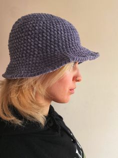 a woman with blonde hair wearing a purple hat